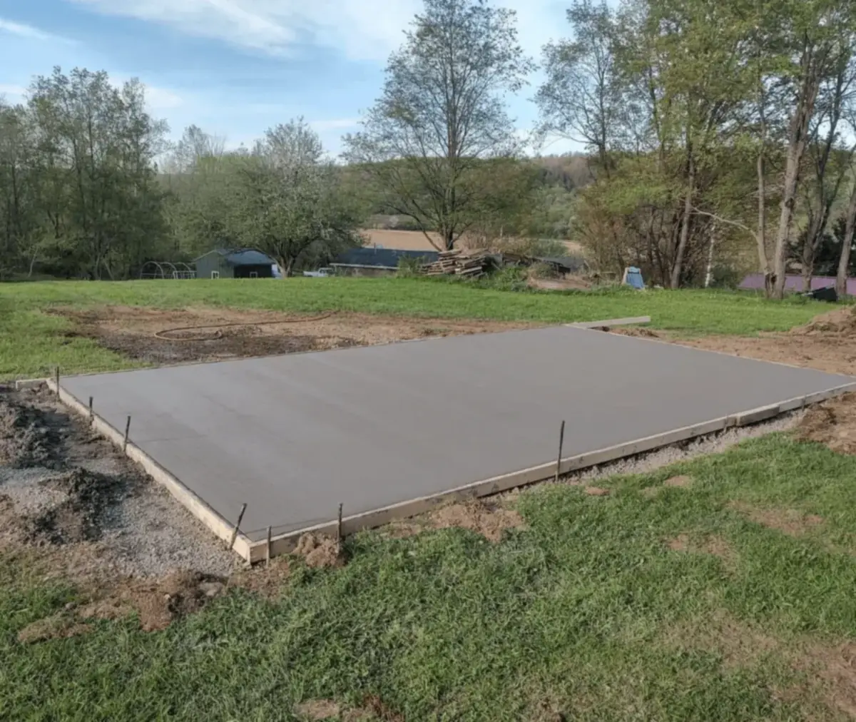 Freshly poured and formed concrete building pad in a rural Western New York field by Cornerstone Concrete of WNY