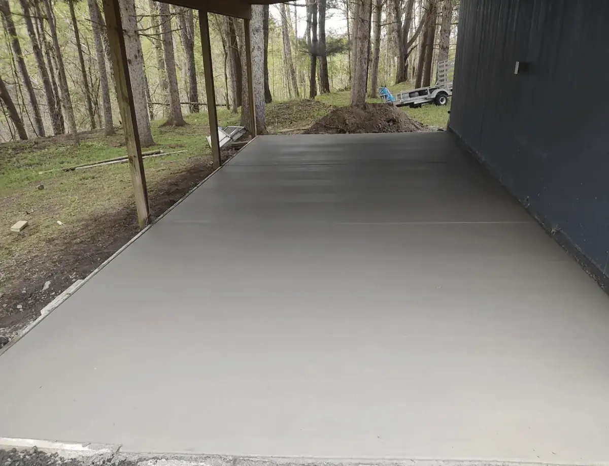 Covered concrete patio slab poured alongside a barn in East Elma NY — Cornerstone Concrete of WNY