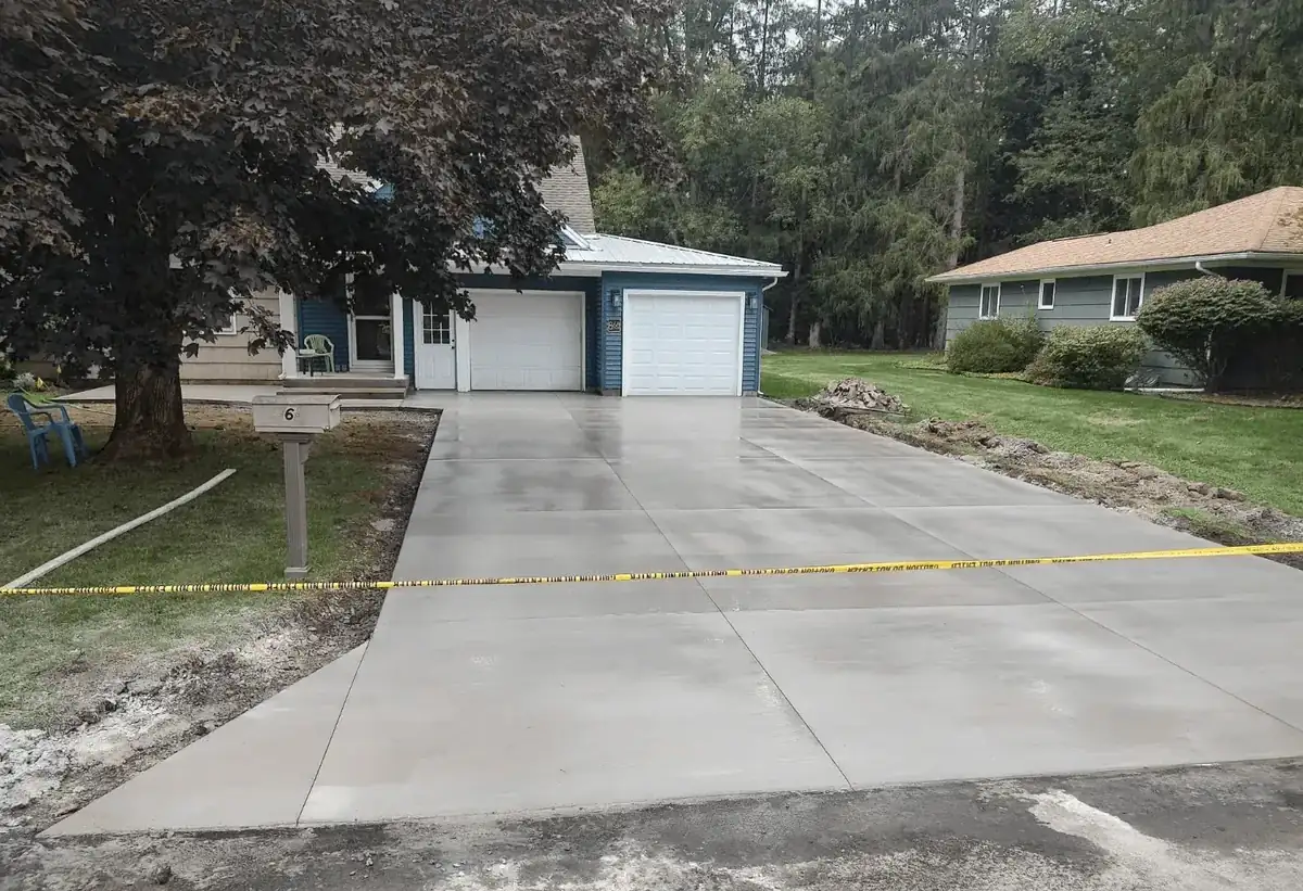 Finished concrete driveway with clean control joints at a home in Orchard Park NY by Cornerstone Concrete of WNY