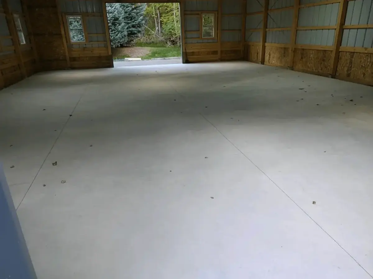 Smooth hard-troweled concrete floor poured inside a pole barn by Cornerstone Concrete of WNY