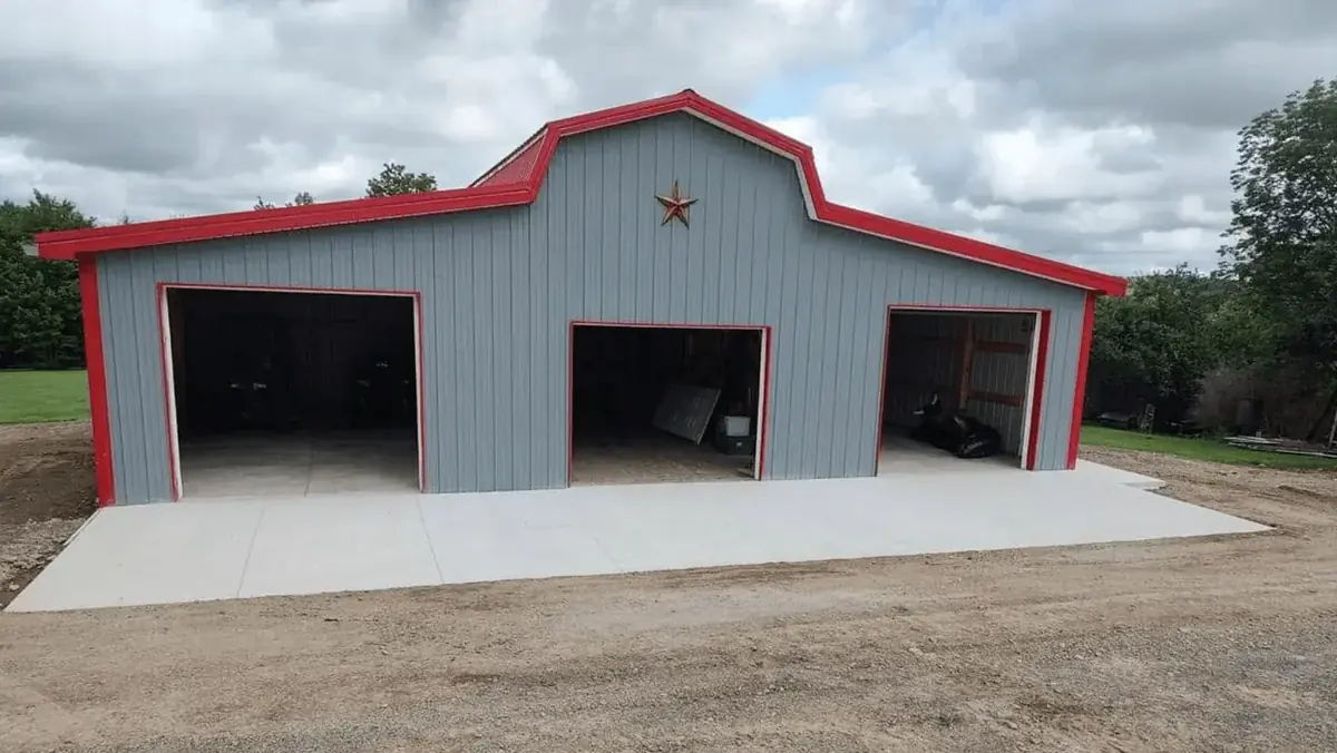 Concrete apron and floor pad poured for a three-bay pole barn with garage doors in East Elma NY by Cornerstone Concrete of WNY